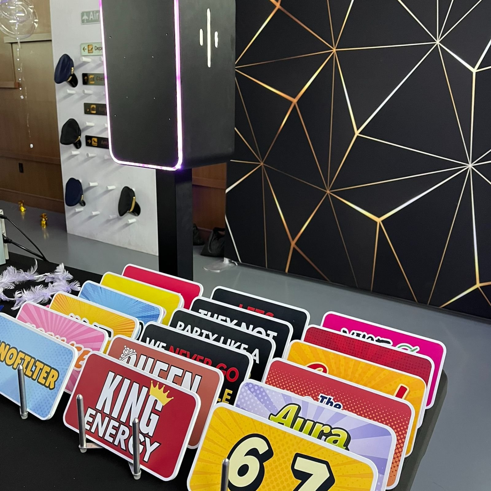 Custom photo booth prop signs displayed on table